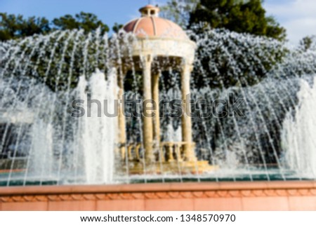 pictured in the photo big beautiful fountain on a bright sunny day, the image does not focus and blurred