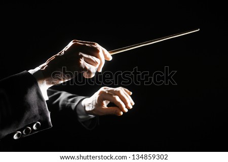 Orchestra conductor hands baton. Music director holding stick Royalty-Free Stock Photo #134859302