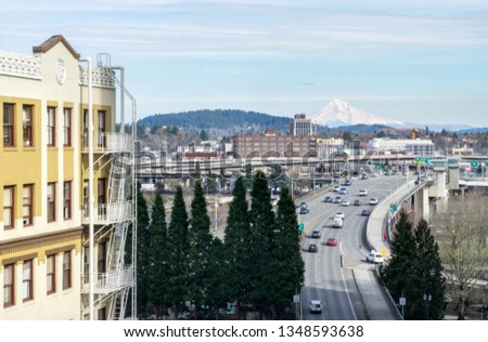 Aerial View of Historic Apartment/Office Building, Bridge, and Highway in Downtown Portland, with Mt. Hood in the Distance - Portland, Oregon, USA