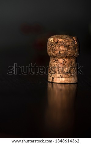 the macro photography picture of champagne cork reflecting on black table font natural rustic handmade material