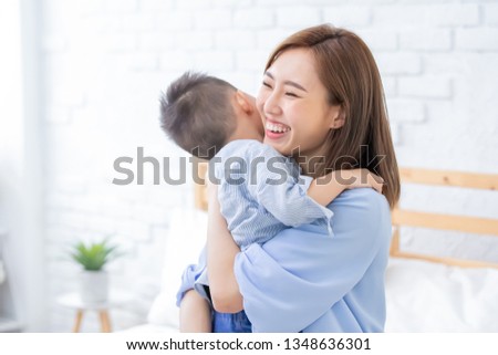 happy family with child boy hug mother at home