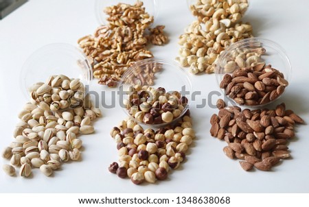 Healthy food. Nuts mix assortment on stone table top view. Collection of different legumes for background image close up nuts, pistachios, almond, cashew nuts, peanut, walnut. image