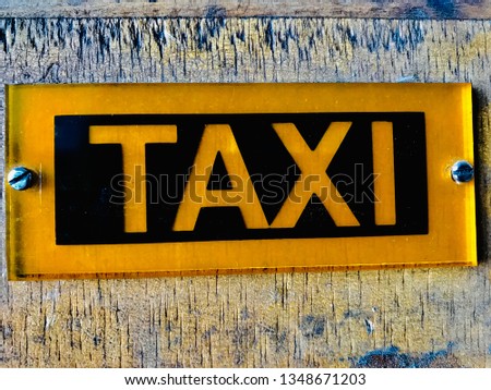 Taxi sign on wood