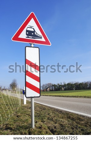 Train warning with a level crossing sign