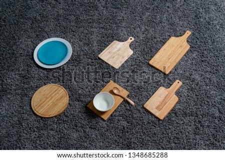 Various kinds of kitchen tools on the grey carpet.