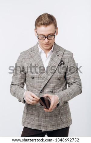 Young handsome man holding a credit card. Studio shot