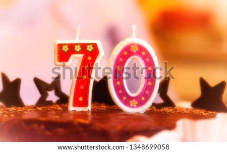 Birthday, 70 years old grandparents. Festive cake with candles. Picture taken in Ukraine. Horizontal frame. Color image. Tint