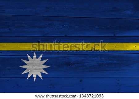 Nauru flag painted on old wood plank. Patriotic background. National flag of Nauru