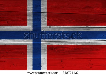 Norway flag painted on old wood plank. Patriotic background. National flag of Norway