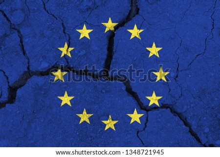 EU flag on the cracked earth. Europe flag. Earthquake or drought concept. brexit