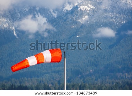Wind cone against a mountain background.