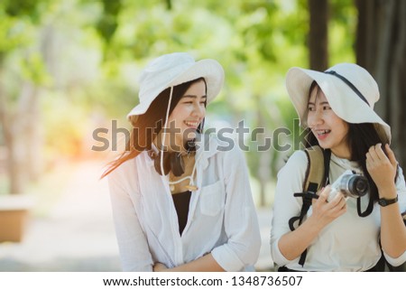 Two Asia women travelling on holiday together with happy.