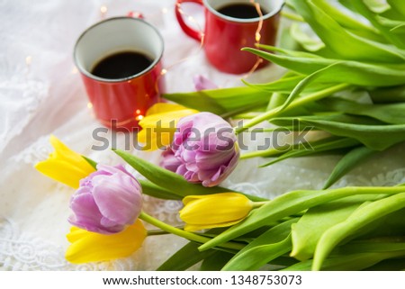 Beautiful morning, two cups of coffee and a bouquet of bright and beautiful tulips