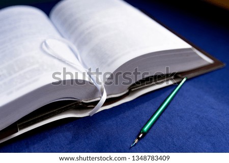 Pages of solved book and pen. Closeup, image
