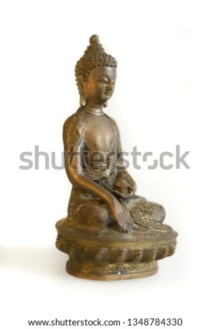 Copper Buddha statue on a white background