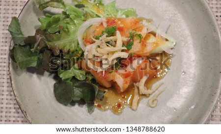 Spicy salmon or yumthai with raw salmon.It is asia food.