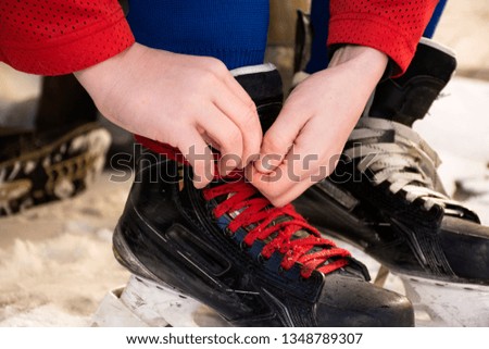Lace up hockey skates. Laces on hockey skates.Tie hockey skates.Tie shoelaces on hockey skates.