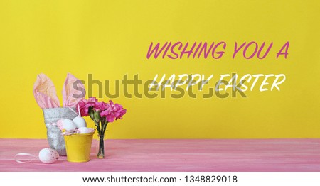 Wishing you a happy easter banner. bunny in a bag , flowers and pink eggs in bucket. yellow background