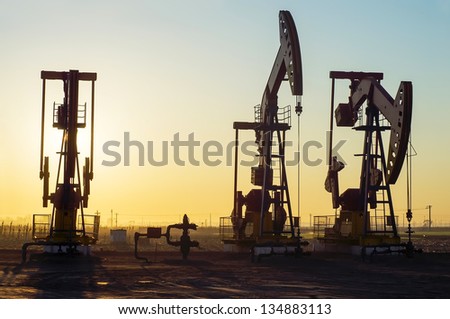  Work of oil pump jack on a oil field. Oil and gas industry.