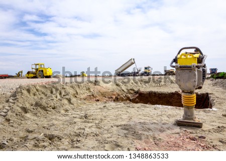 Small plate compactor, vibratory hammer, jumping jack machine, power tool at construction site Royalty-Free Stock Photo #1348863533