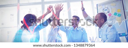 Stocks and shares against photo editors high-five in meeting room