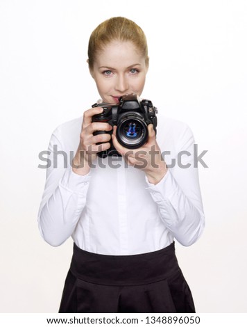 Portrait of a girl with a camera on a white background.