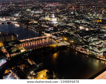 Aerial cityscape of London illuminated at night with view of St Paul's Cathedral