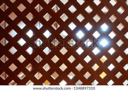 Decorative wooden lattice. Wooden background with light source at the back.
