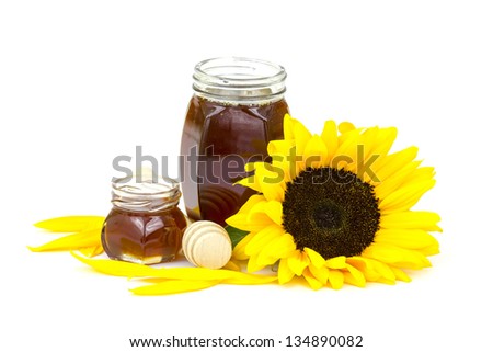 honey and sunflowers on white background