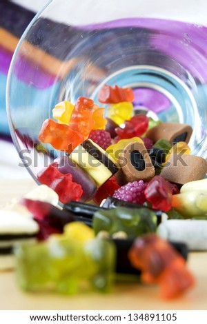 gummy candies pouring from the bottom of glass