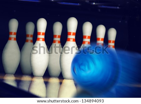 Motion blurred bowling ball on alley