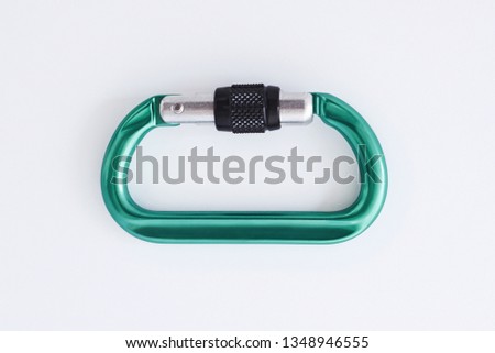 Touristic extreme sports. Isolated photo of climbing equipment - green colored part of carabiner.