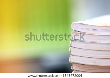 Close-up pictures of many books stacked on blurred background. soft focus
