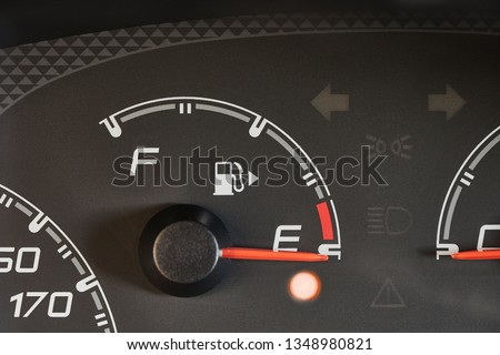 Fuel indicator of a car running out of fuel, warning light glowing