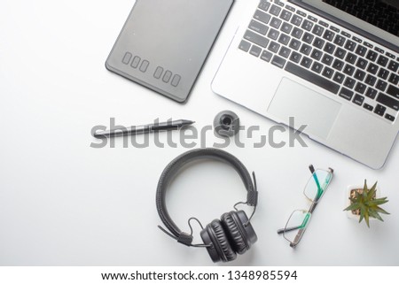 Desktop designer and creative retoucher with a graphics tablet, laptop, glasses. Design, flat lay