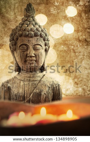 attractive textured picture of a Buddha figure with floating candles in a stone bowl