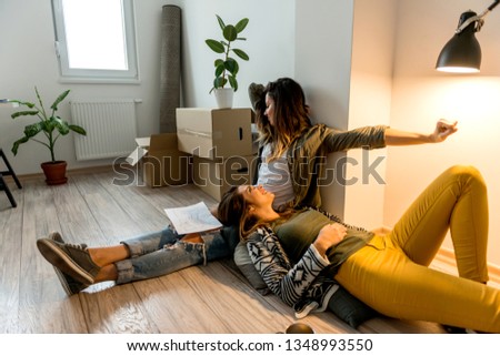 Lesbian couple enjoying their new apartment