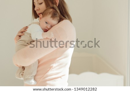 Young Mother holding newborn baby in arms