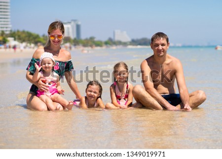 Big happy family is having fun at beach. concept of a large family at sea. beach fashion