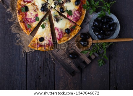 Sliced pizza with Mozzarella cheese, tomatoes, olive. top view