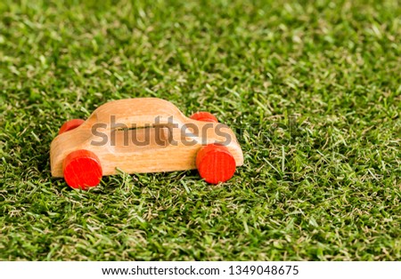 Wooden car on grass background