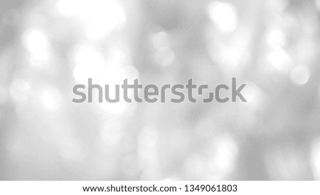 Abstract photo of round bokeh lights in silver, black and white tone for glossy blurred background and grey decoration. Cool banner on ad, page, presentation, and website