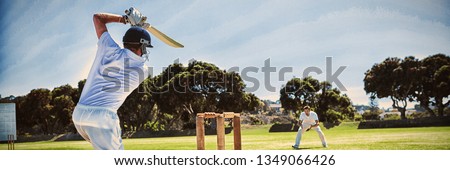 Rear view of player batting while playing cricket on field against clear sky