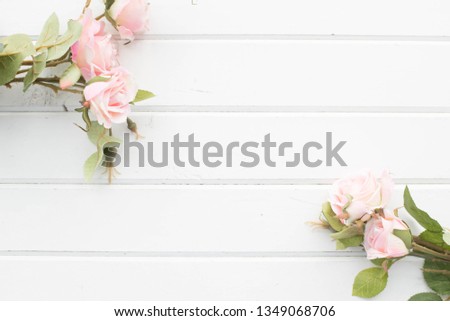 Artificial rose on the background of white boards