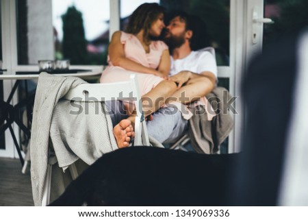 Young couple in love on the terrace of their home.