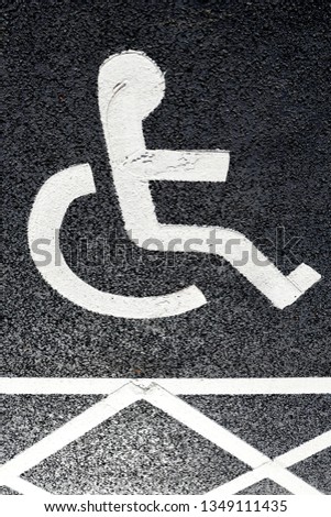 White painted Disability parking spaces on a tarmac surface.