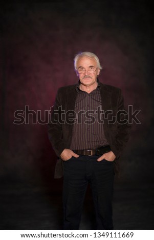Charismatic man posing in the studio on a colored background