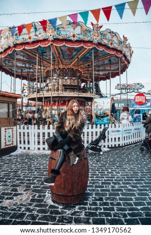 German good-looking young girl enjoying her time in Moscow through winter holiday  on New Year's Fair