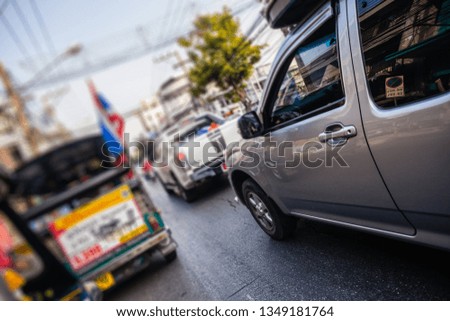 A busy street in Thailand with a lot of traffic. Shallow depth of field.