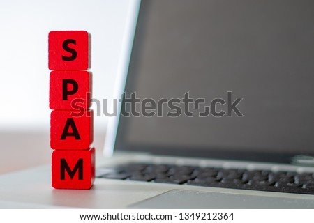 Red cubes with the lettering Spam on top of an open laptop 